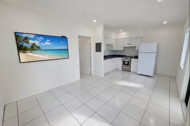 a kitchen with stainless steel appliances granite countertop a refrigerator and a stove top oven