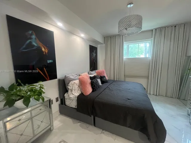 a bedroom with bed and a potted plant