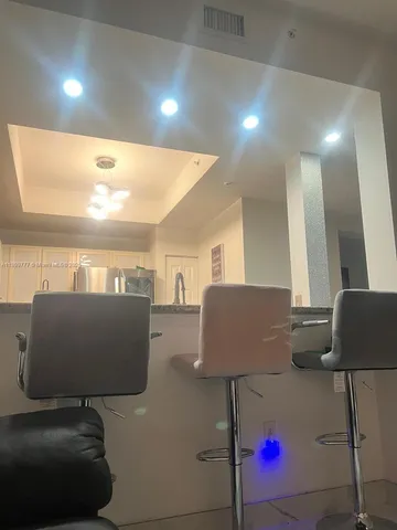 a living room with furniture and a lamp