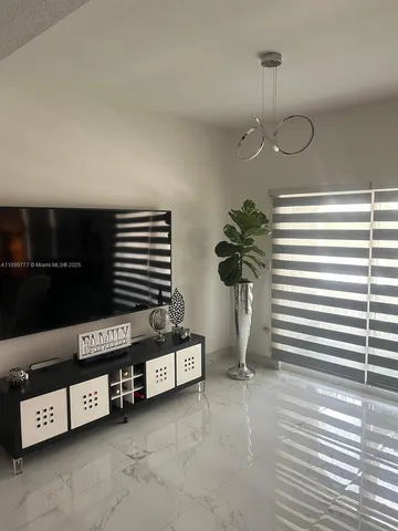 a view of a livingroom with furniture and a potted plant