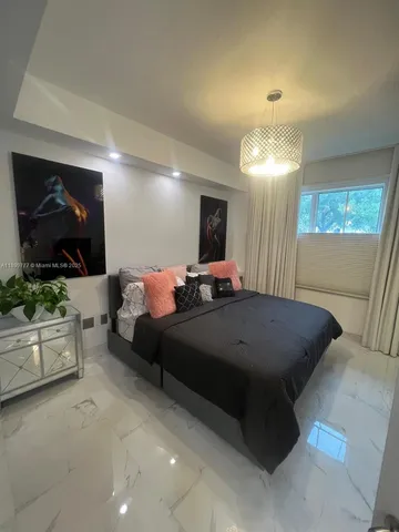 a bed room with furniture and a flat screen tv