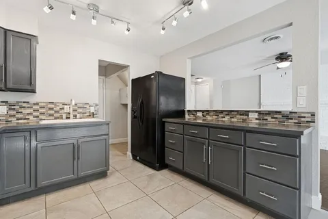 a kitchen with stainless steel appliances granite countertop a refrigerator and a sink