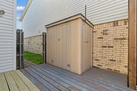 a view of a house with wooden deck