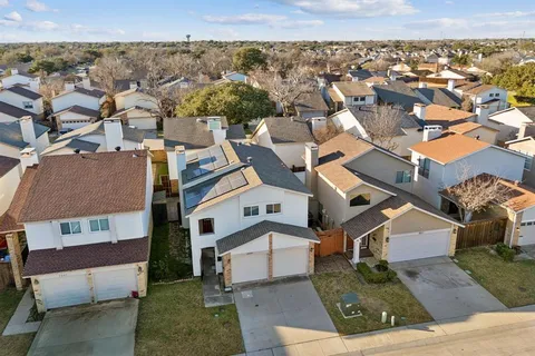 an aerial view of residential houses with outdoor space