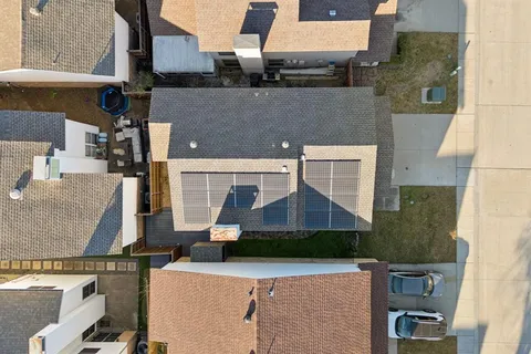 an aerial view of a house with a yard