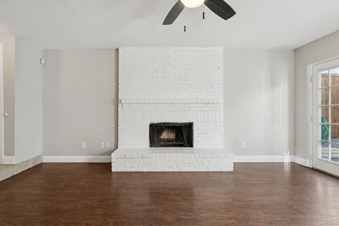 a view of a livingroom with a fireplace and window
