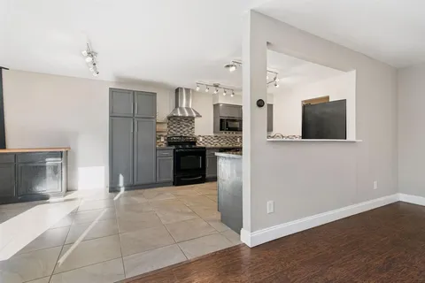a kitchen with stainless steel appliances granite countertop a stove and a refrigerator