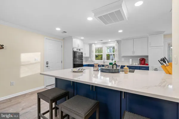 a kitchen with stainless steel appliances granite countertop a sink and cabinets