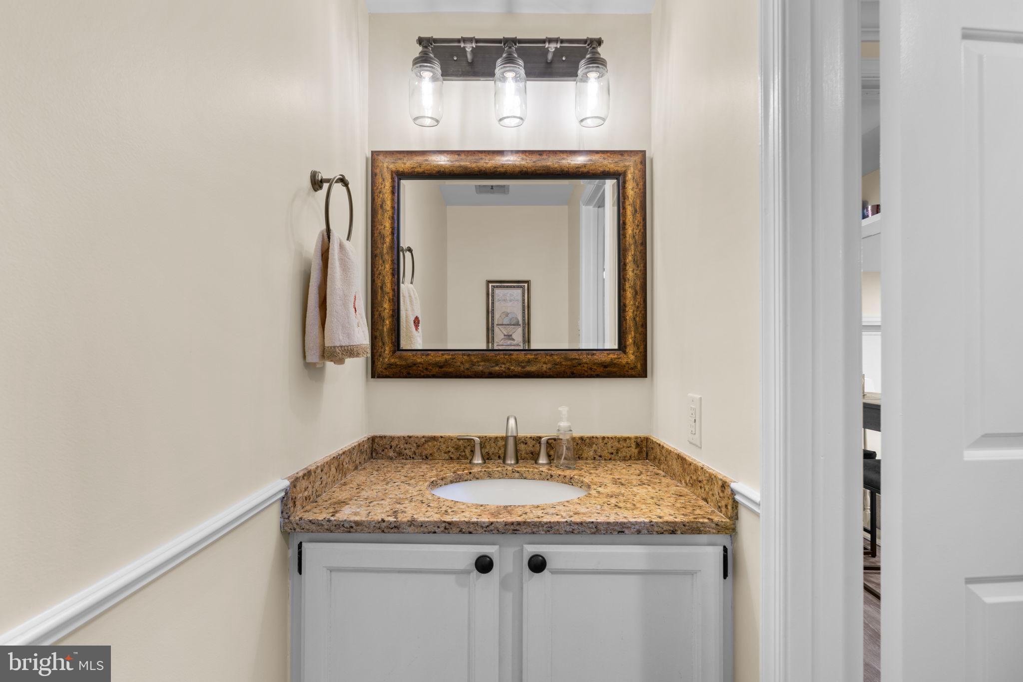 9413 Sunfall Court Columbia, MD 21046 - Photo 32 of 71 a bathroom with a granite countertop sink and a mirror