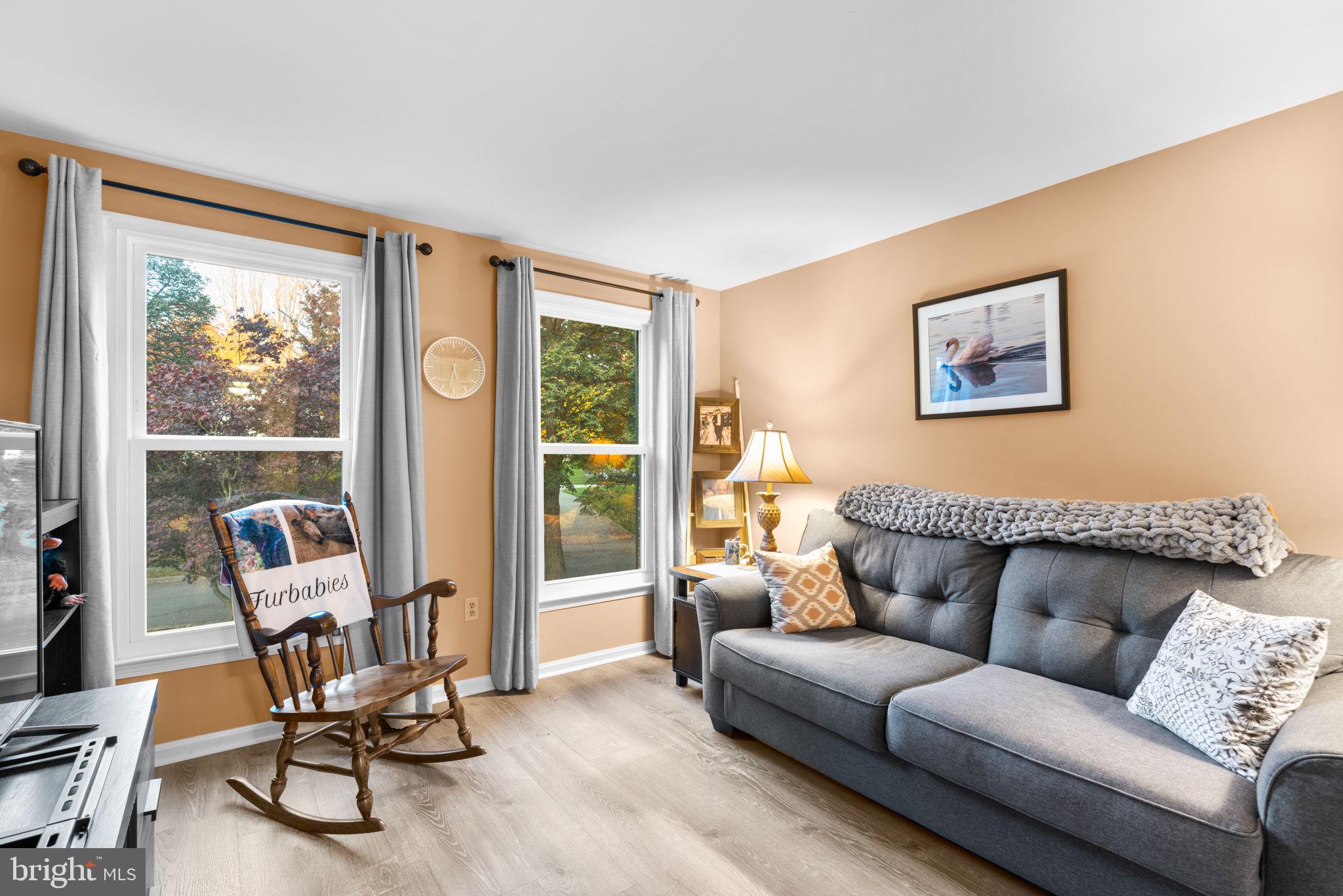 9413 Sunfall Court Columbia, MD 21046 - Photo 33 of 71 a living room with furniture and floor to ceiling windows