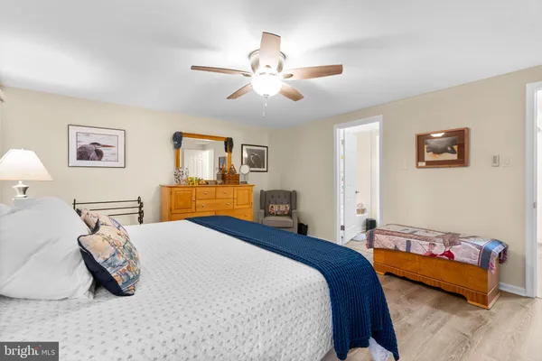 a bathroom with a granite countertop sink a toilet and mirror