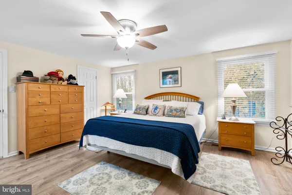 a bathroom with a granite countertop toilet sink and mirror