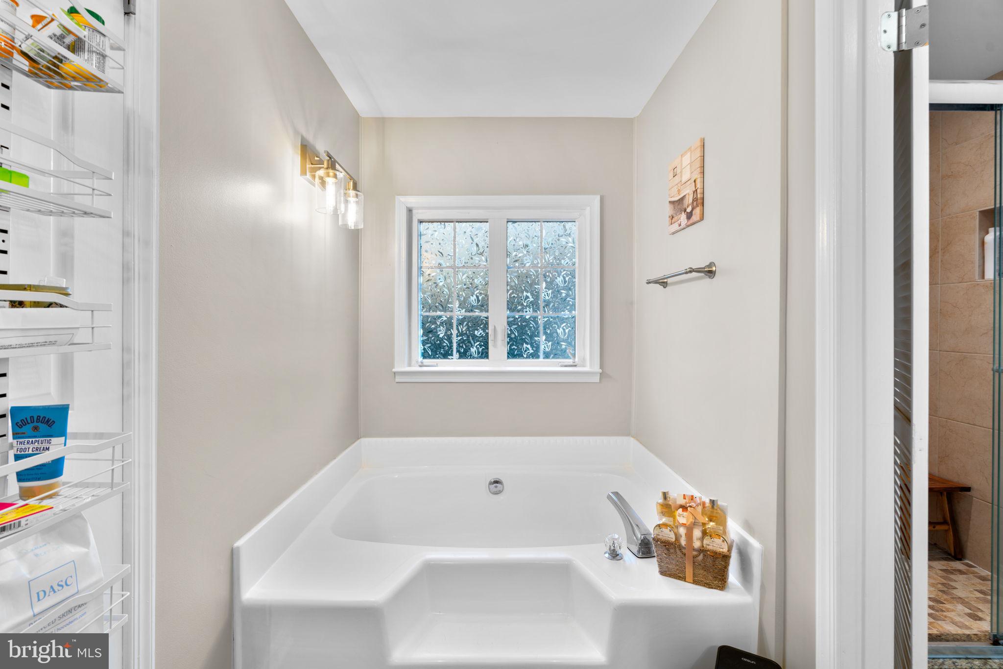 9413 Sunfall Court Columbia, MD 21046 - Photo 39 of 71 a bathroom with a bathtub and a window