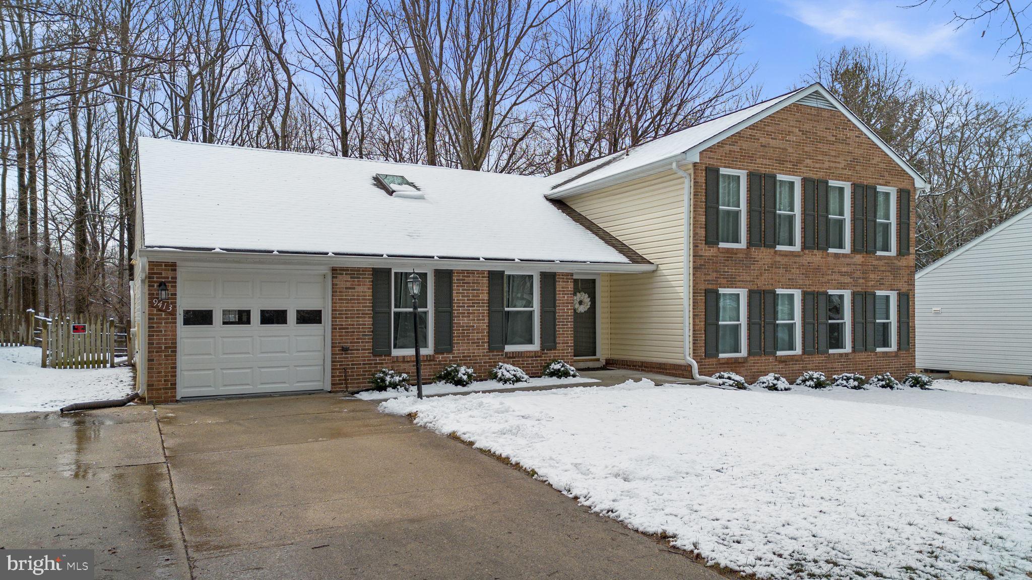 9413 Sunfall Court Columbia, MD 21046 - Photo 60 of 71 a front view of a house with a yard covered in snow