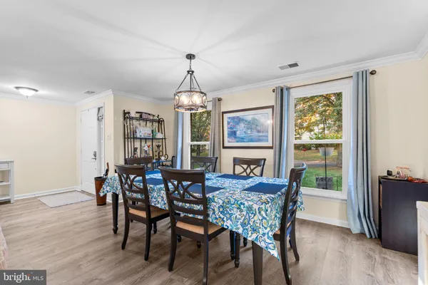 a living room with fireplace furniture and a wooden floor