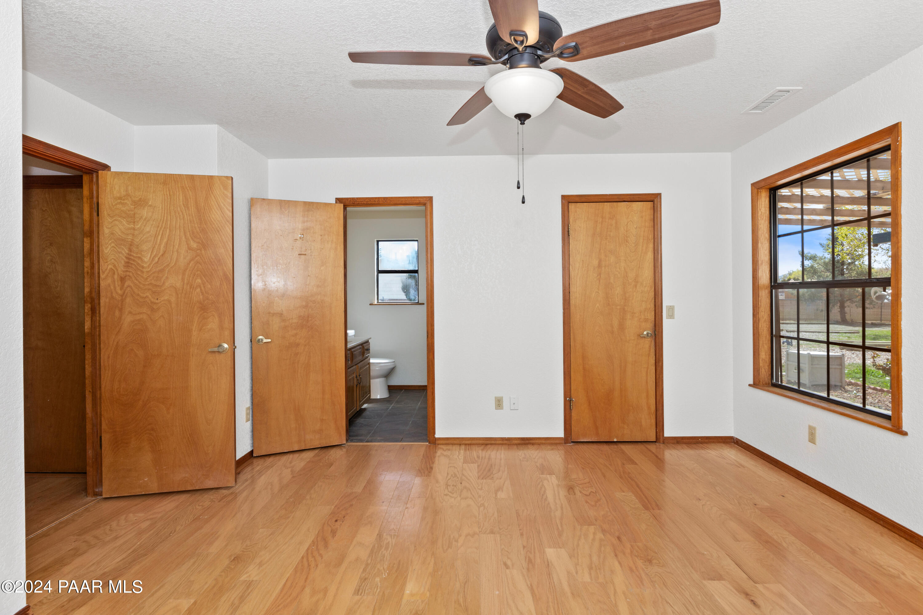 2170 Val Vista Drive Chino Valley, AZ 86323 - Photo 12 of 33 a view of an empty room with a window and wooden floor