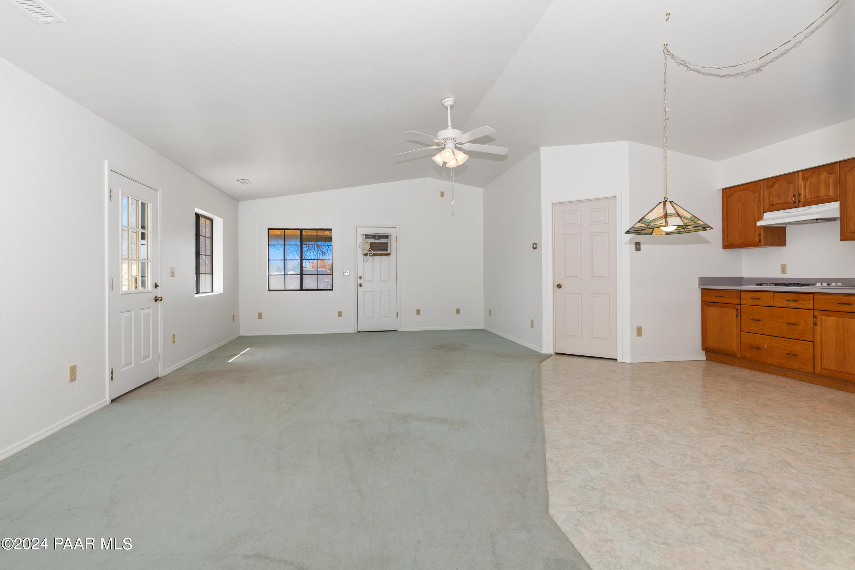 2170 Val Vista Drive Chino Valley, AZ 86323 - Photo 22 of 33 an empty room with chandelier fan and windows