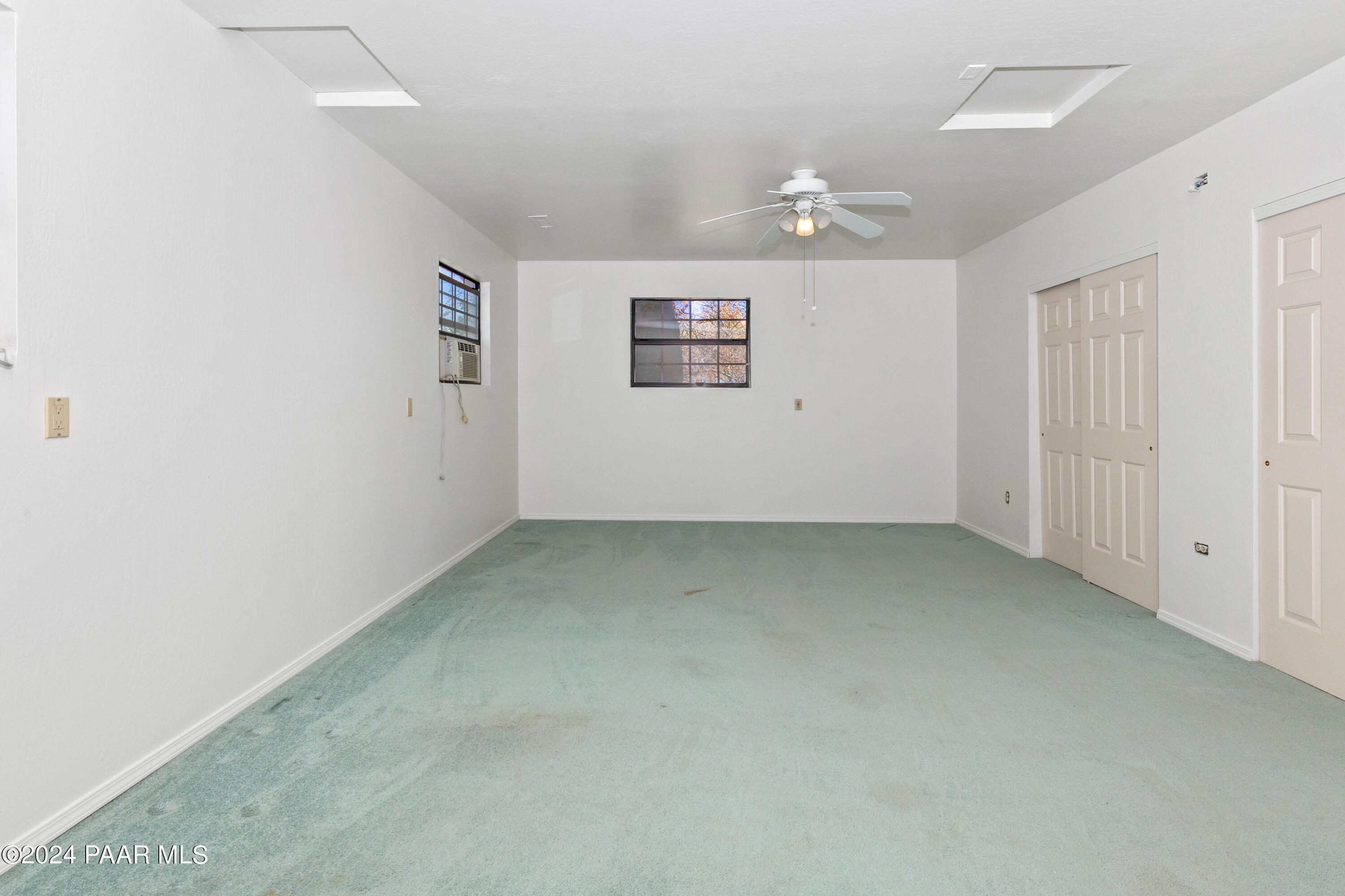 2170 Val Vista Drive Chino Valley, AZ 86323 - Photo 24 of 33 an empty room with a ceiling fan and window