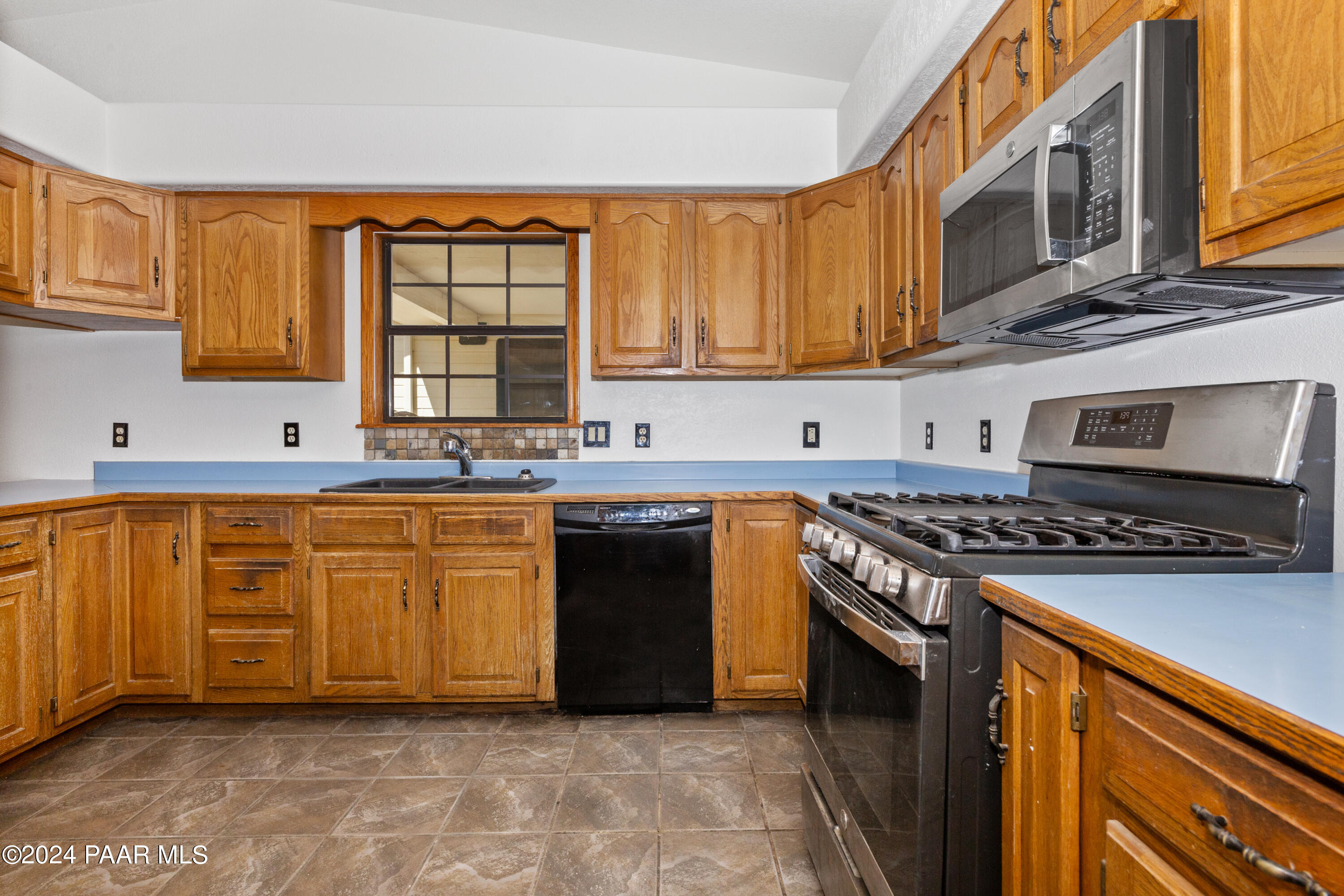 2170 Val Vista Drive Chino Valley, AZ 86323 - Photo 8 of 33 a kitchen with stainless steel appliances granite countertop a stove a sink and a microwave