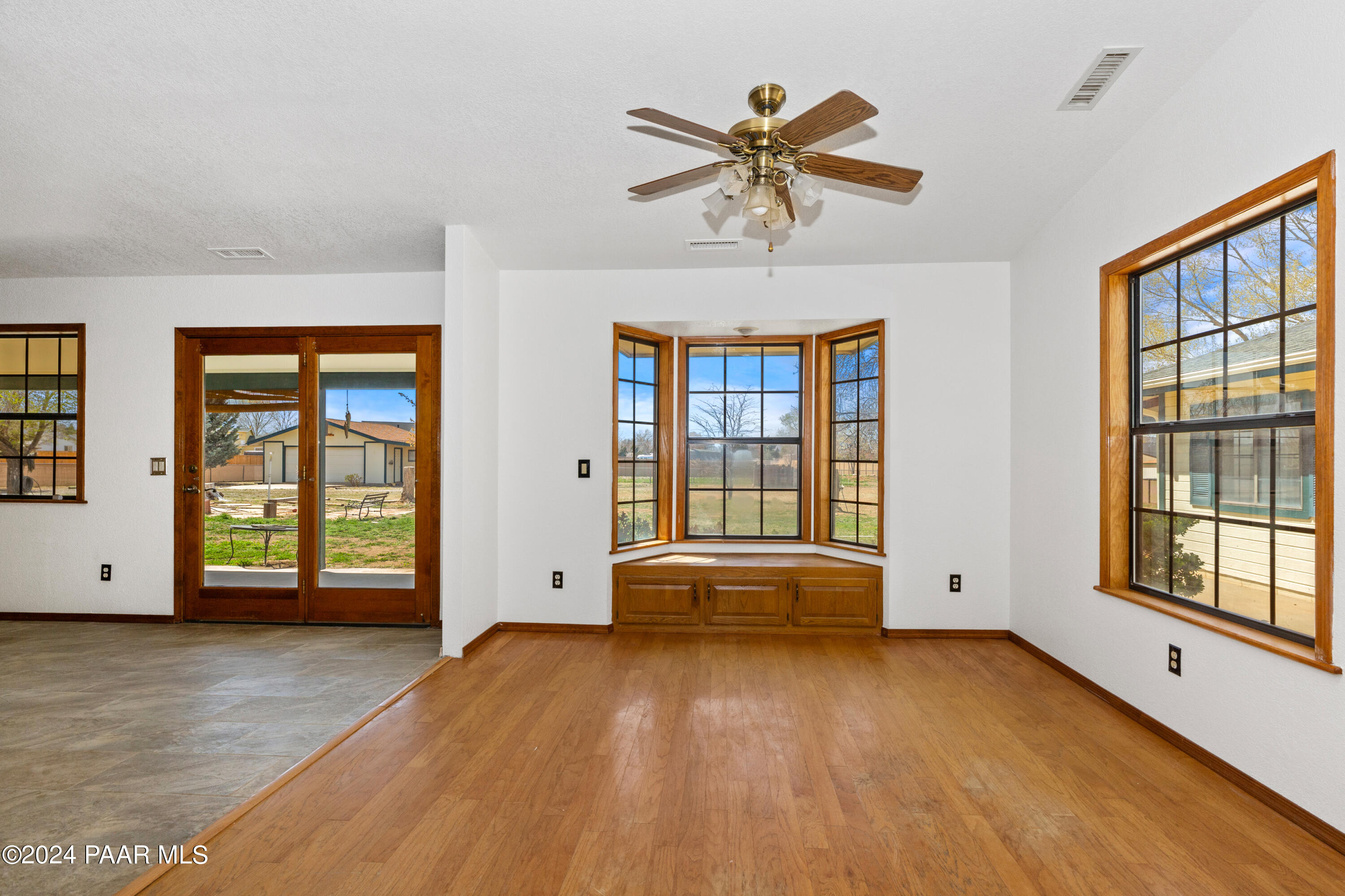 2170 Val Vista Drive Chino Valley, AZ 86323 - Photo 10 of 33 a view of an empty room with a window and wooden floor