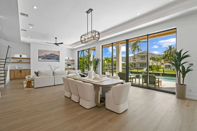 a kitchen with stainless steel appliances granite countertop a sink a stove and a wooden floors