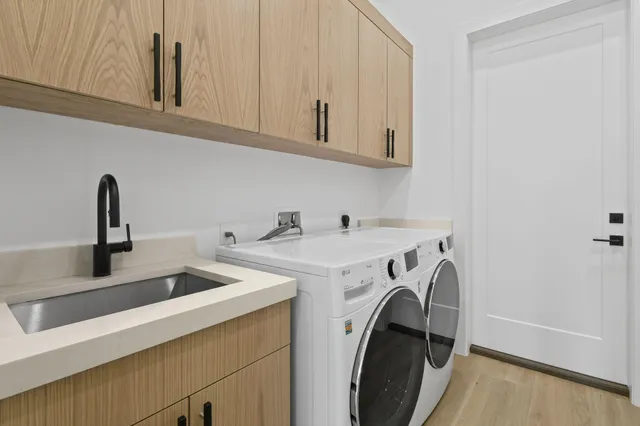 a spacious bathroom with a double vanity sink a mirror and a bathtub