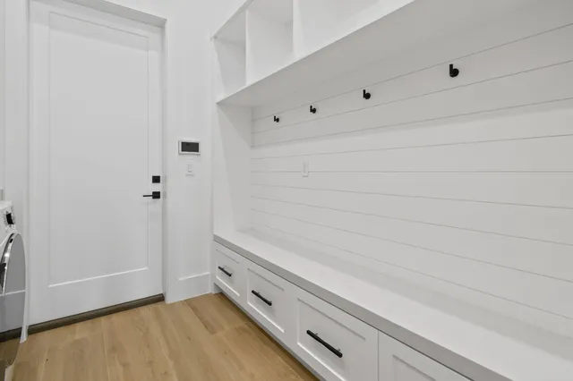 a view of a room with wooden floor and wall painting