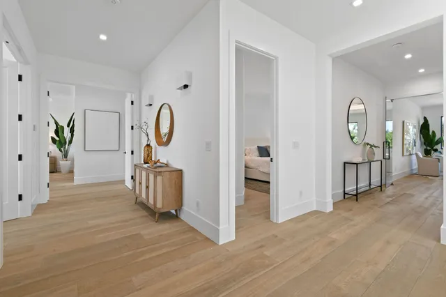 a bedroom with bed and a flat tv screen on dresser