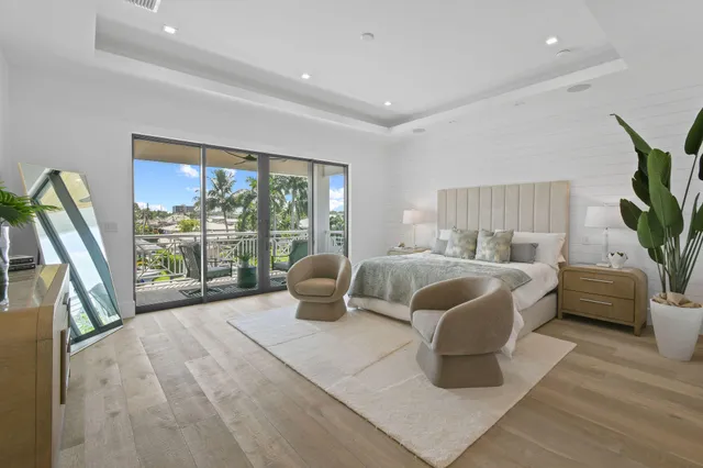 a bedroom with a bed and a potted plant