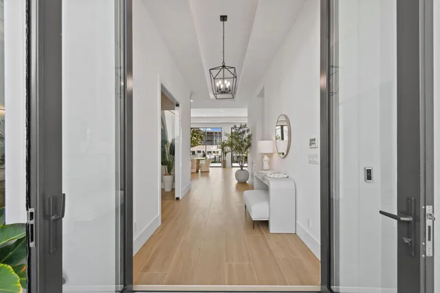 a view of a hallway with wooden floor fireplace and living room