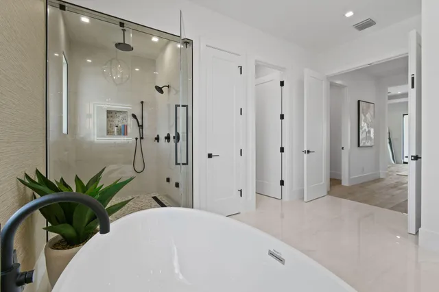 a view of a patio with couches and table and chairs and floor to ceiling window with outer view