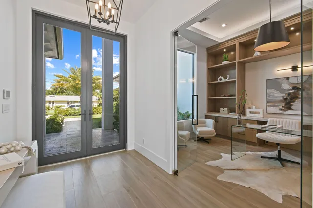 a living room with furniture and a floor to ceiling window
