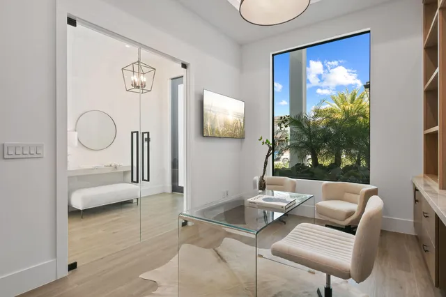 a kitchen with a sink and wooden floor