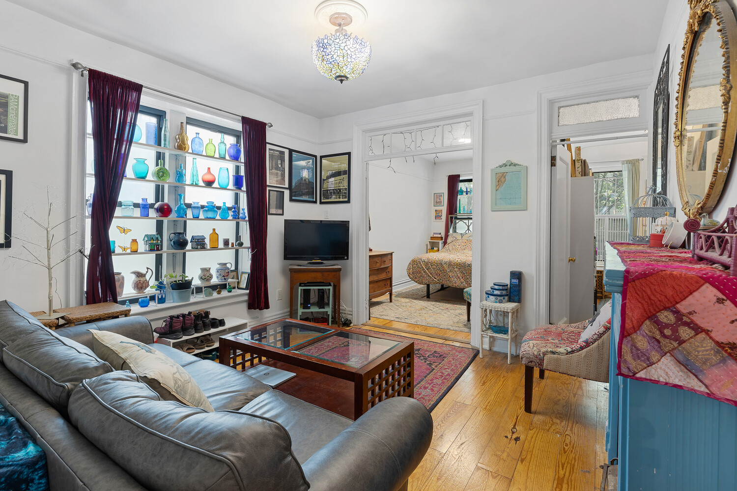214 Bradhurst Avenue, Unit 4 Manhattan, NY 10039 - Photo 3 of 11 a living room with furniture a flat screen tv and a fireplace