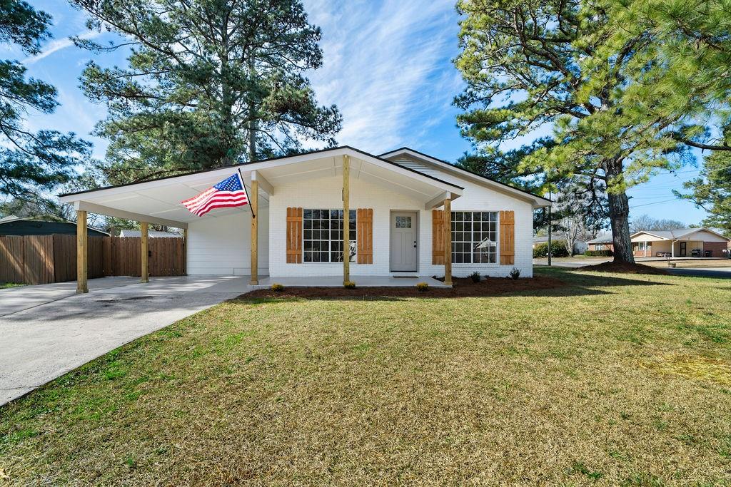 a front view of a house with a garden