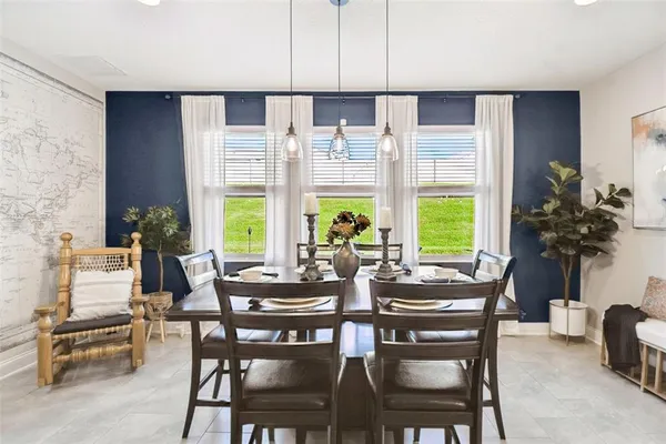 a bedroom with a bed and a chandelier fan