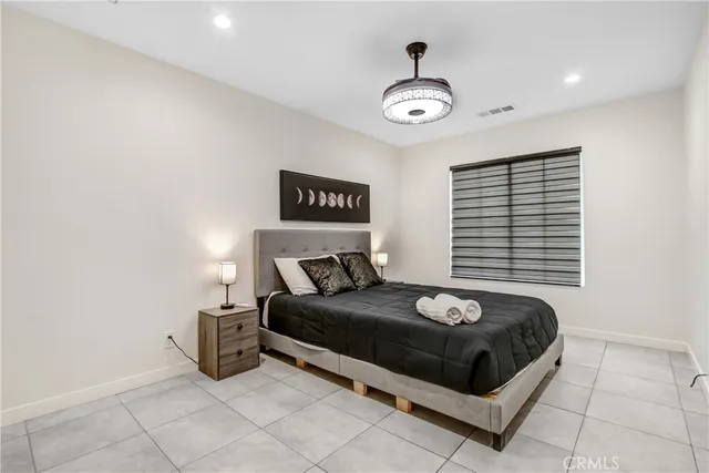 a bedroom with a bed and a large window