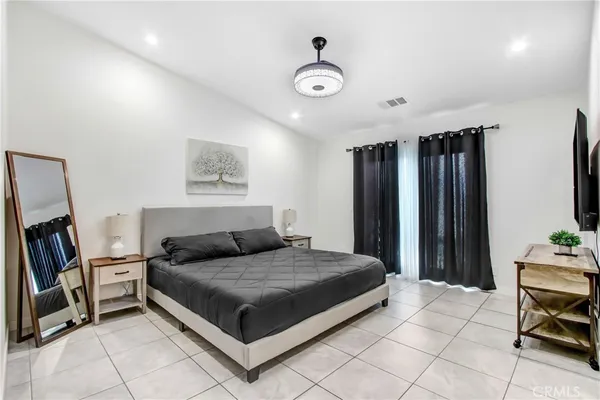 a bedroom with a bed and a television in it