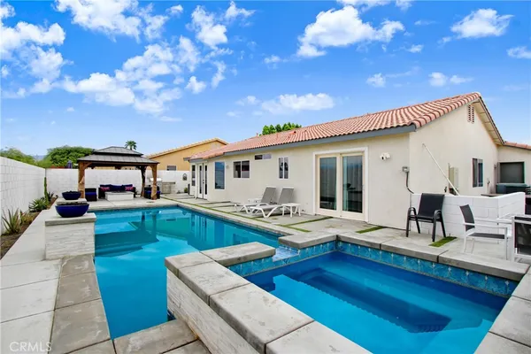 a view of a house with pool porch and furniture