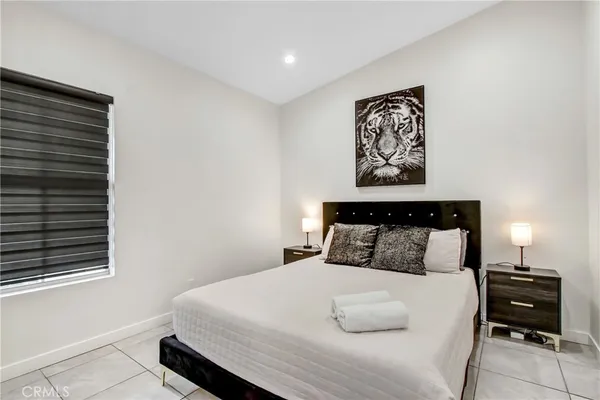 a bedroom with a bed and a night stand