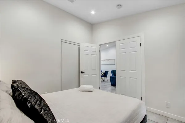a bedroom with a bed and a walk in closet