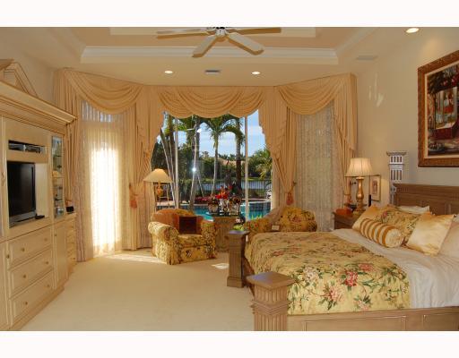 3796 Northwest Coventry Lane Boca Raton, FL 33496 - Photo 11 of 16 a bedroom with furniture and a flat screen tv