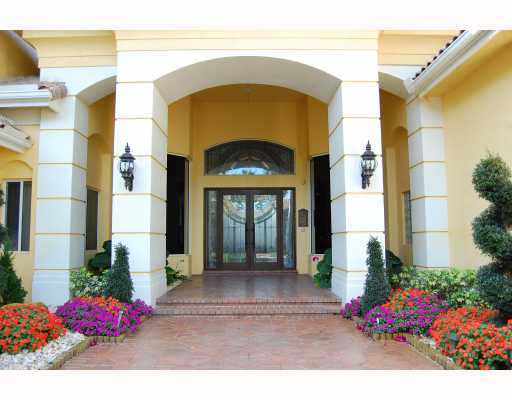 3796 Northwest Coventry Lane Boca Raton, FL 33496 - Photo 4 of 16 a front view of a house with a yard