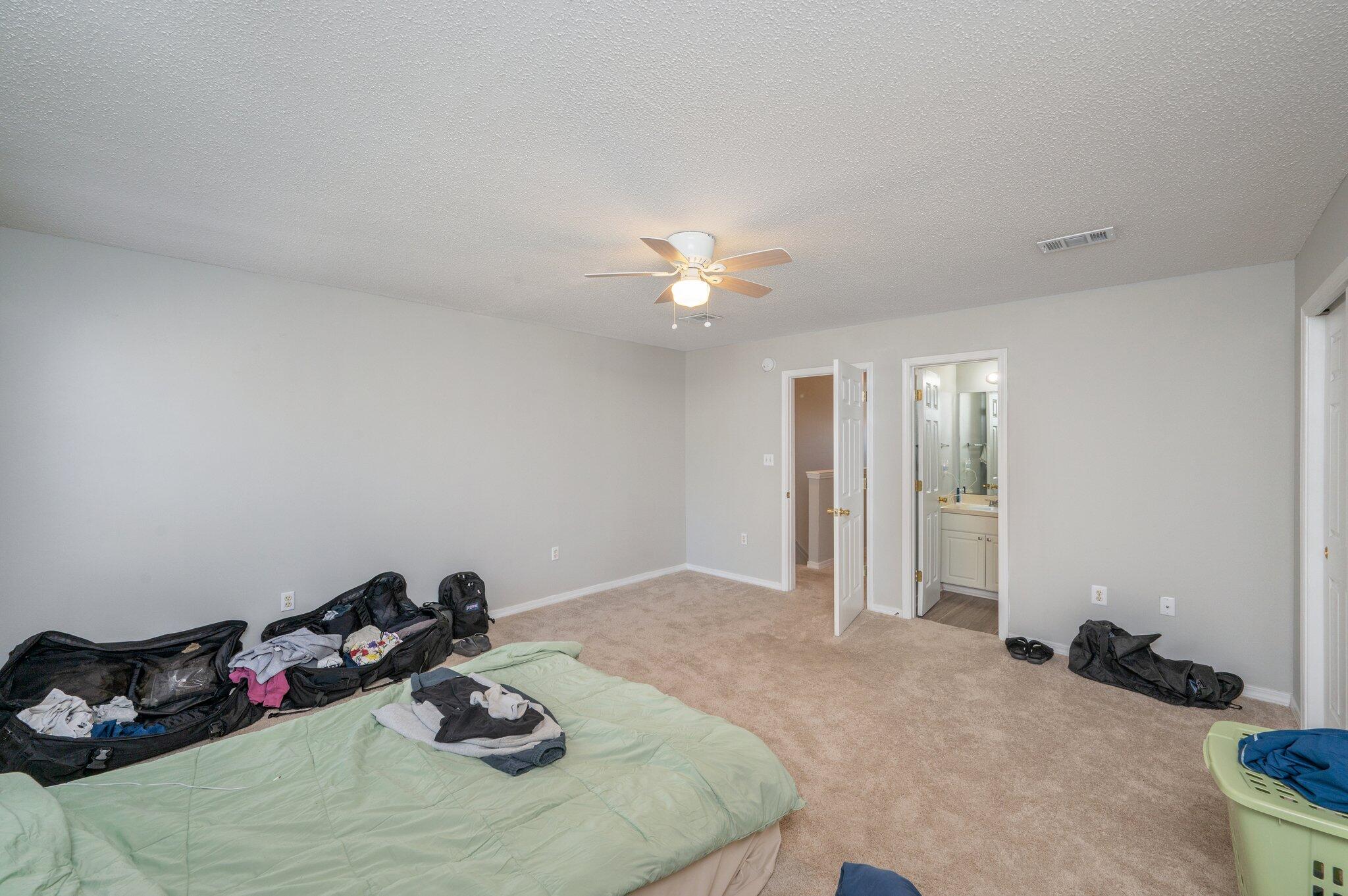 472 Keystone Road Mary Esther, FL 32569 - Photo 11 of 12 a bedroom with a bed and a chandelier