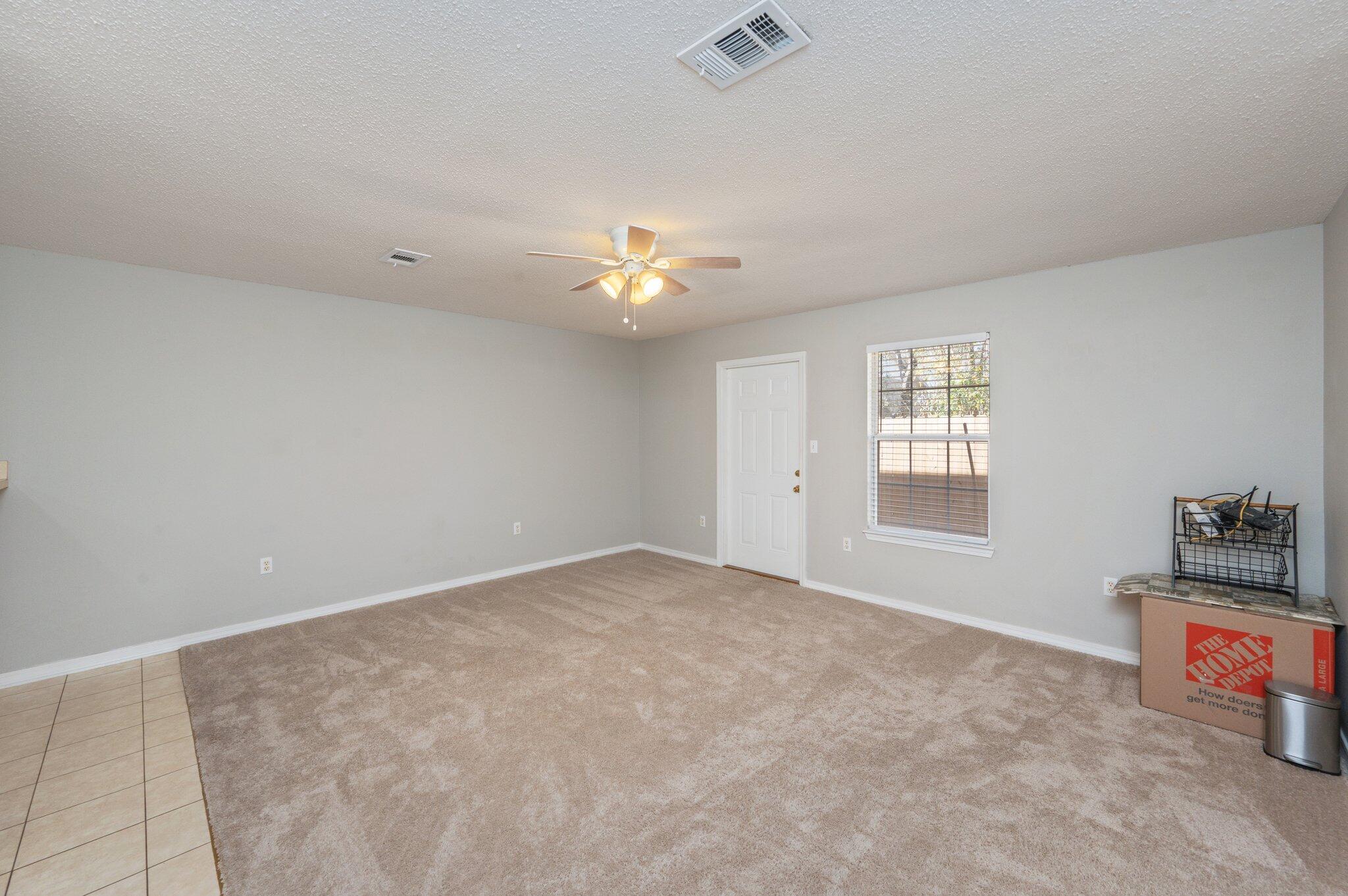 472 Keystone Road Mary Esther, FL 32569 - Photo 4 of 12 an empty room with windows and fan