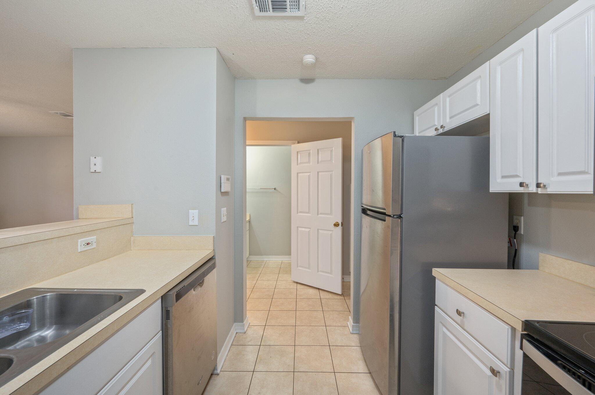 472 Keystone Road Mary Esther, FL 32569 - Photo 6 of 12 a kitchen with a refrigerator sink and cabinets