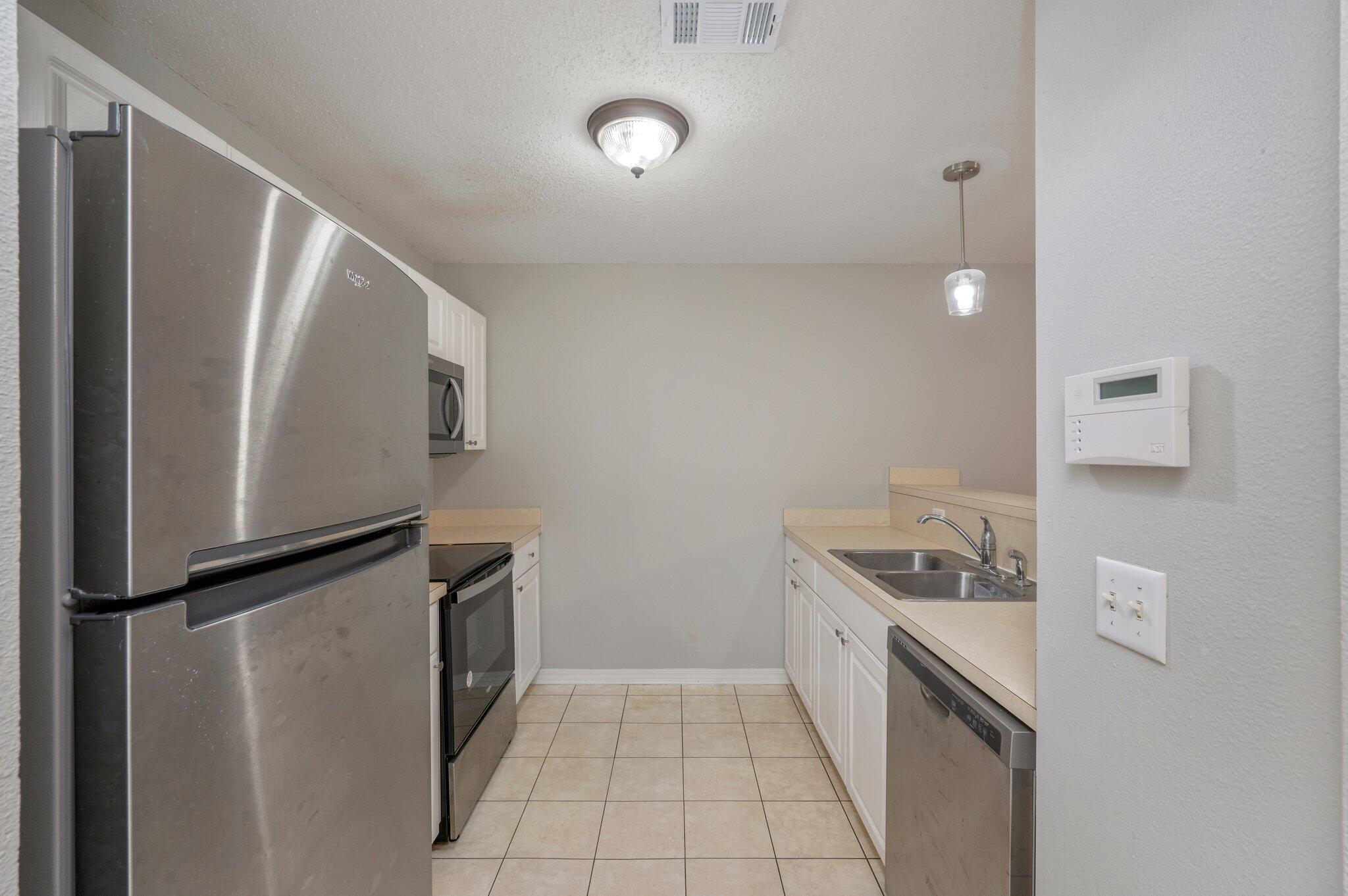 472 Keystone Road Mary Esther, FL 32569 - Photo 7 of 12 a kitchen with a refrigerator and a sink