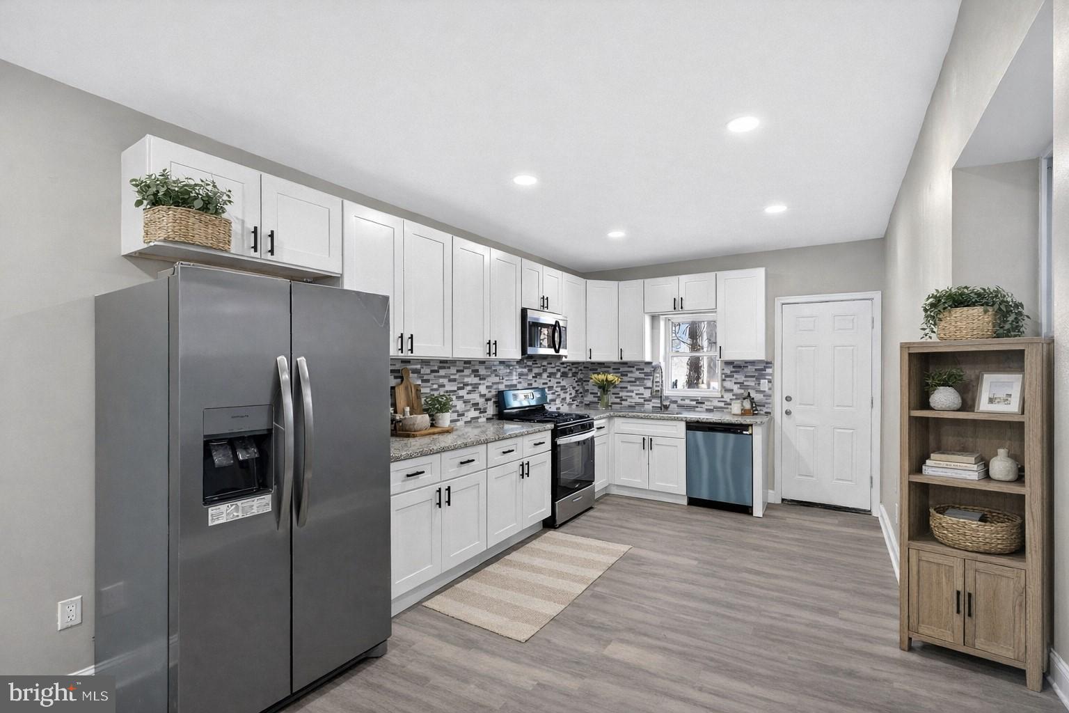 5443 Irving Street Philadelphia, PA 19139 - Photo 12 of 50 a kitchen with stainless steel appliances granite countertop a refrigerator sink and stove
