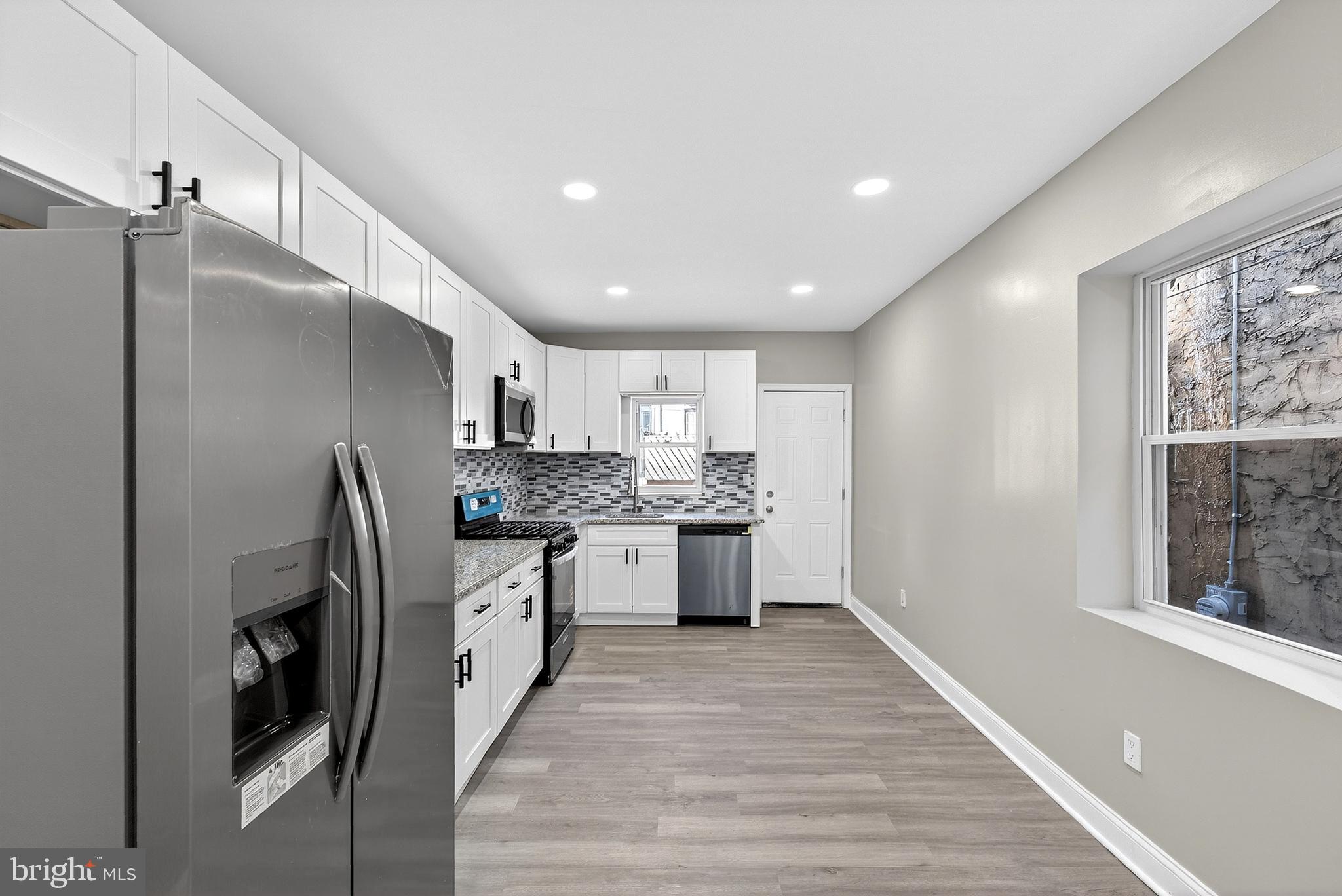 5443 Irving Street Philadelphia, PA 19139 - Photo 15 of 50 a kitchen with stainless steel appliances granite countertop a refrigerator and a sink