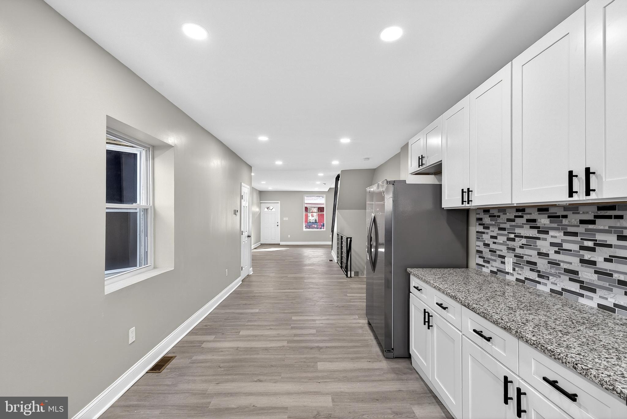 5443 Irving Street Philadelphia, PA 19139 - Photo 17 of 50 a kitchen with stainless steel appliances granite countertop a refrigerator and stove